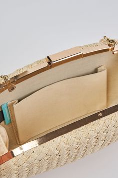 In a Natural tone, this versatile clutch is an ideal summer accessory. With a hard casing featuring a hand woven outer, we adore the detachable beaded shell strap and easy metal snap closure. Crafted to complement our Corsica collection, this charming oval-shaped bag is a must-have clutch of the season. Chic Rectangular Straw Clutch, Chic Rectangular Straw Bag, Elegant Straw Bag With Adjustable Strap, Elegant Clutch As Fashion Accessory For Spring, Elegant Spring Fashion Accessory Clutch, Chic Woven Travel Clutch, Chic Rectangular Straw Bag With Pearl Handle, Rectangular Clutch For Spring, Chic Woven Clutch For Travel