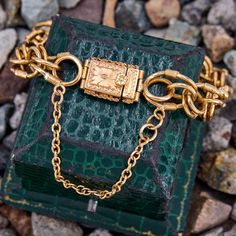 This unique fancy link bracelet is made from 19k yellow gold and its stamps indicate it was crafted in Porto Portugal between 1938 and 1984. It is finished with a beautifully engraved box clasp and safety chain. Rectangular Gold Bracelet With 17 Jewels, Vintage Gold Bracelet With Oval Link For Formal Occasions, Vintage Oval Link Gold Bracelet For Formal Occasions, Gold Timeless Chain Bracelet With Box Clasp, Luxury Gold Chain Bracelet With Clasp, Timeless Gold Chain Bracelet With Box Clasp, Timeless Engraved Chain Bracelet For Formal Occasions, Victorian Yellow Gold Bracelet For Formal Occasions, Heirloom Gold Bracelet Collectible