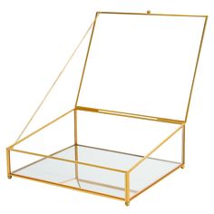 a glass and gold box with a chain hanging from the bottom, on a white background