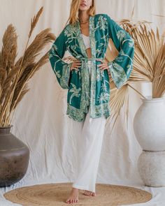 Our Aphrodite Short Kimono, made from soft viscose double gauze fabric, offers a luxurious feel and an ethereal appearance. Designed to enhance your presence in any setting, its flowing silhouette and lightweight, breathable fabric ensure a graceful and comfortable fit. Ideal for lounging by the pool or attending special events, this piece is perfect for making a statement. Its versatile design provides multiple styling options, making it an indispensable addition to your wardrobe. Celebrate your divine beauty and radiate grace with our reversible Short Kimono. Elegant Long Sleeve Sleepwear For Vacation, Elegant Flowy Sleepwear For Loungewear, Chic Long Sleeve Kimono For Loungewear, Viscose Sleepwear For Summer, Chic Relaxed Fit Sleepwear For Vacation, Chic Relax Fit Sleepwear For Vacation, Casual Relaxed Fit Kimono For Loungewear, Chic Flowy Kimono For Loungewear, Rayon Kimono For Loungewear