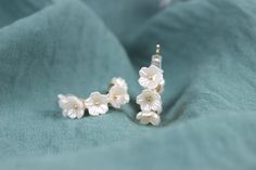 These white floral silver earrings are handmade women earrings. These earrings are simple and elegant accessories that you can easily match with any outfit. These earrings are perfect for gifting yourself or your loved ones. They are great gift options for birthday, wedding, engagement, anniversary, Valentine's day, Mother's day, graduation or any special occasion. These earrings come with gift box and personalized note. The size of the earrings is 1 cm. Color: Gold & White Style: Bridal, Weddings, Special Days, Summer Style Gender: Unisex Shape: Floral, Pearl Material: Cubic zirconia Return policy Our products have a one-day preparation period, during which you can cancel or change your order. If you want to make a return or exchange after your order has been shipped, the shipping charges Delicate White Jewelry With Matching Earrings, Dainty Flower Earrings With Ear Wire For Wedding, White Dainty Bridal Earrings For Parties, White Flower Earrings With Ear Wire For Party, White Round Flower Earrings For Wedding, Elegant Flower-shaped Hoop Earrings For Wedding, White Flower Earrings For Wedding, Elegant Flower Earrings Gift For Her, Dainty White Pearl Earrings For Party