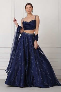 Navy blue lehenga with Swarovski crystals, sequin and bead embellishments. Paired with draped corset blouse and net dupatta.
Component: 3
Pattern: Embellished
Type Of Work: Swarovski crystals, Sequin, Bead
Neckline: Sweetheart
Sleeve Type: Sleeveless
Fabric: Satin, Net
Color: Blue
Other Details: 
Embellished details
Draped corset
Flared lehenga
Net dupatta
Occasion: Wedding, Reception - Aza Fashions Royal Blue Lehenga, Navy Blue Lehenga, Sangeet Outfit, Simple Lehenga, Indian Outfits Lehenga, Lehenga Designs Simple, Lehenga Blouse Designs, Gaun Fashion, Blue Lehenga