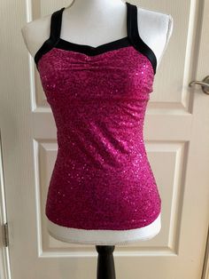 Pink Fuchsia Womens Dance Top Sequins Stretch Black Trim Criss Cross Back Pinch Front Detail  Material: Spandex/lyrca two-way stretch with small sequins Womens XSMALL  Measurements:     *Bust 28-30"    *Waist 26-28"    *Hips 28-30"    *Center front - hem 16.5" Hand wash cold Made in USA  A5 Fitted Pink Tank Top With Built-in Bra, Stretch Dancewear Tops For Sports, Stretch Dancewear Tops, Stretch Tops For Dancewear And Sports, Spring Stretch Dancewear Tops, Stretch Pink Tops With Built-in Bra, Sleeveless Stretch Dancewear Tops, Stretch Tops For Dance, Pink Stretch Tank Top For Party