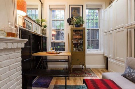 Peep Inside NYC's Coolest Tiny Apartment #refinery29  http://www.refinery29.com/tiny-nyc-apartment-ideas#slide-6  A pocket table unfolds from the cabinet. New York Studio Apartment, West Village Apartment, Affordable Apartments, Micro Apartment, Tiny Apartments, Small Apartment Living, New York Apartment, Tiny Apartment, Nyc Apartment