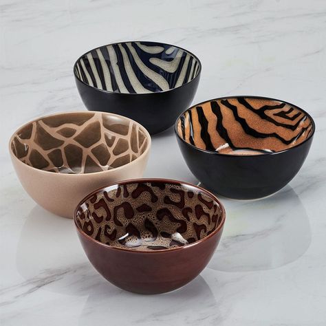 This Amari Dinnerware Bowl Set features four animal print designs: cheetah, zebra, tiger, and giraffe, on a distinctive reactive glaze finish. Due to the nature and hand-crafted qualities of reactive glaze, no two pieces are exactly alike and will exhibit unique variations in color and pattern. Product may slightly differ from image shown.• 12-piece set, service for 4, includes 4 each 8-1/2 inch dinner bowl with a 38-fluid ounce capacity, 6 inch pasta bowl with a 25-fluid ounce capacity, and a 9 Ceramic Plate Set Dinnerware, Kitchen Apt Decor, Cheetah Print Living Room Decor, Dishwear Sets Dinnerware, Dish Sets Dinnerware Unique, Leopard Print Home Decor, Cute Plates And Bowls, Unique Dishware, Kitchenware Aesthetic