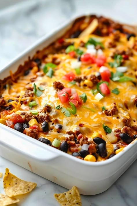 This heart taco casserole is bound to be a hit! Packed with ground beef, beans, corn, salsa, and gooey cheese, it's perfect for any fiesta. Simple Taco Casserole Ground Beef, Taco Casserole Bake Pioneer Woman, Taco Casserole For A Crowd, Taco Bell Casserole, Simple Taco Casserole, Macaroni And Ground Beef Casserole, Casseroles With Beans, Cheesy Taco Casserole Recipes, Whole 30 Taco Casserole