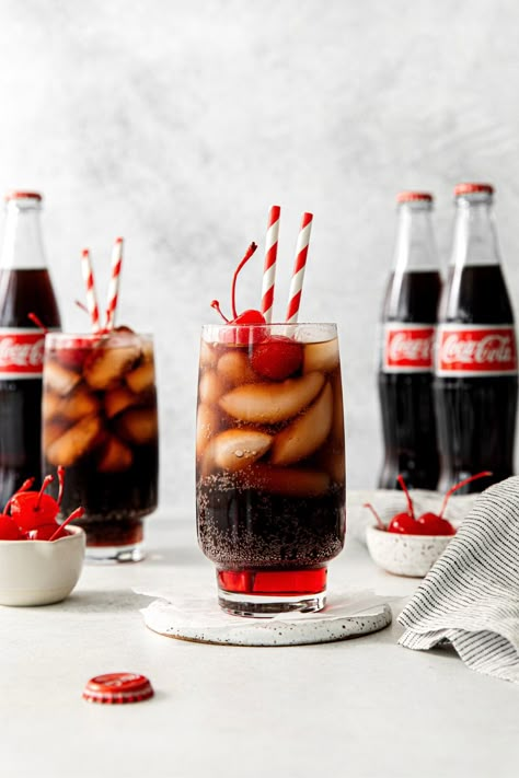 An old-fashioned Roy Rogers drink served in a tall glass with maraschino cherries and straws. Cold Drink Photography, Coca Cola Photography, Food Widget, Roy Rogers Drink, Peppermint Fizz, Coca Cola Aesthetic, Coca Cherry, Cherry Core, Drink Pictures