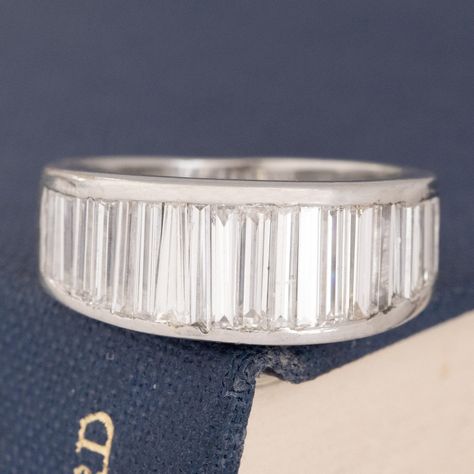 One of our fave band looks with baguettes - one with tapering/graduated baguettes! These are incredibly hard to manufacture and even rarer to find vintage ones too! Gorgeous on the finger - perfect for the right hand! Platinum Size 4.75 & resizable slightly. Diamonds are natural and Earth-mined, G/H colors & VVS/VS clarities. GIA Standards 7.9mm Wide Please see qualitative report for more information. Baguette Diamond Band, Baguette Diamond, Diamond Band, Diamond Bands, Right Hand, Diamonds, Size 4, Band, Baguette