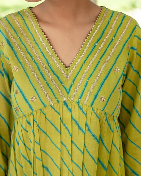 ~HARMONY OF HUES~ Lehariya Collection - New Arrivals! A fresh vibrant look with teal Lehariya contrasting against a lime green base. Rows of silver gota enhance the elegant neckline and sleeve cuffs. This is a standout piece for festive occasions. [ Cottons Jaipur, Cotton, Lehariya, Rajasthan, Handcrafted, Traditional, Ethnic] #cottons #cottonsjaipur #newarrivals #rajasthan #heritage #traditional #lehariya #lehariyasuits #kurta #craftmanship #indianart #colours #indian #ethnic #cottonkur... Cotton Lehriya Kurti Designs Latest, Lehriya Kurti Designs, Lehariya Kurti Designs, Leheriya Kurti, Cottons Jaipur, Kurti Neck Design, Embroidery Kurti, Neck Patterns, Long Frock Designs