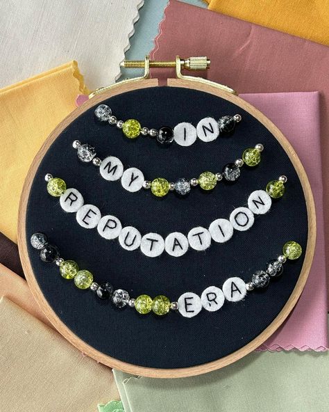 Reputation friendship bracelet photos! This piece was a lot of fun to make, and I’ve got a few more in the works! I had to skip over the bewjeweled one for a while because it was a lot of letter beads. Why did I do that to myself? 😅 But very soon I will have 3 more of these to show you! P.S. I’m already planning ahead with fabric and beads for The Tortured Poets Department! . . . #taylorswift #taylorswiftfanart #friendshipbracelets #swiftie #swiftieart #taylorswiftcrafts #handmadetaylorart ... Letter Bead Ideas, Letter Beads Ideas, Reputation Friendship Bracelet, Embroidered Ornaments, Loft Fashion, Stitch Stuff, Camp Style, Embroidery Works, Cross Stitches