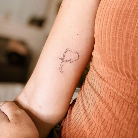 Minimalist line art elephant tattoo on the inner arm. Best Elephant Tattoo, Elephant Tattoo Line Art, Simple Line Art Tattoos For Women, Minimalist Elephant Tattoo Simple, Elephant Micro Tattoo, Elephant And Sun Tattoo, Tattoo Of Elephant, Aesthetic Elephant Tattoo, Elephant Tattoo Placement Ideas