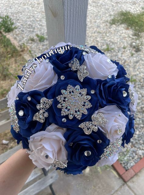 An elegant and beautiful bouquet! Customize bouquets are also available if needed. Different colors and brooches. 10inches in diameter You are welcome to message me and I will reply quick :) Hablo español 😊 Royal Blue And Gold Quince Bouquet, Quinceanera Flower Bouquet Blue, Royal Blue Ramo Quince, Quince Blue Decorations, Quince Dark Blue Theme, Royal Blue Bouquet Quinceanera, Royal Blue Quince Bouquet, Royal Blue Xv Decorations, Royal Blue Ramo