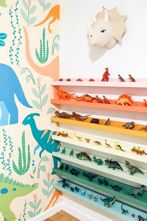 diy dinosaur shelf. Do you have a kid's room and need some toy storage ideas? I made rainbow dino ledges for my boy's bedroom. Childen's books would also work on these shelves. Click through for the full tutorial. Dinosaur Shelf, Boys Dinosaur Bedroom, Dinosaur Kids Room, Dino Room, Kids Bedroom Storage, Diy Dinosaur, Toy Storage Ideas, Dinosaur Room Decor, Dinosaur Bedroom