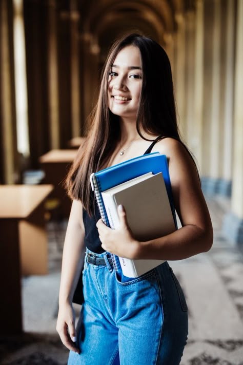 Confident asian student holding books an... | Free Photo #Freepik #freephoto #books #computer #education #woman Hold Book Reference, College Student Photo, Student Portrait Photography, Pose With Book Reference, Carrying Books Pose, Person Holding Book Reference Drawing, Holding Books Reference, Holding Books Pose, Student Pose Reference