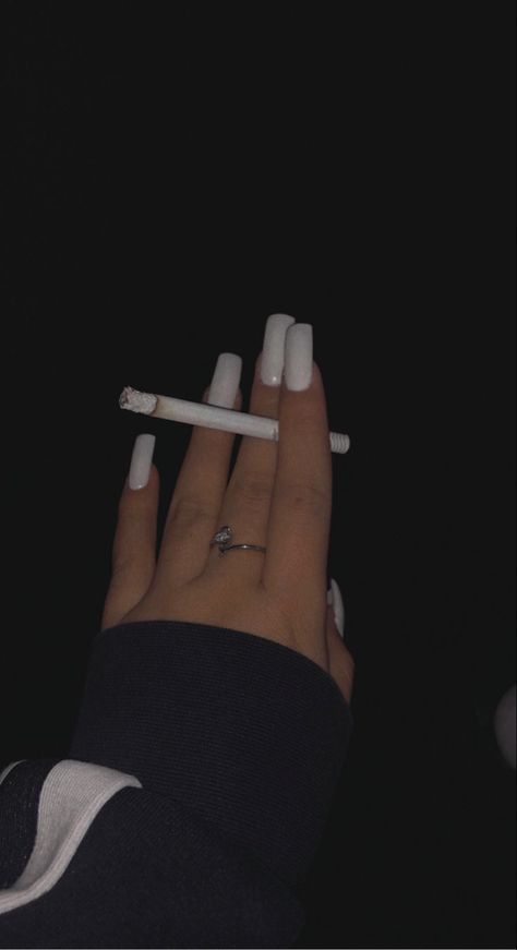 White nails and smoking a cigarette Ciggaretes Aesthetics, Nails And Ciggaretes, Cigrate Girl Hand, Lipstick On Ciggarates, Lana Del Rey Ciggaretes, Peyton List, Nike Tech, Girly Acrylic Nails, Cute Selfie Ideas