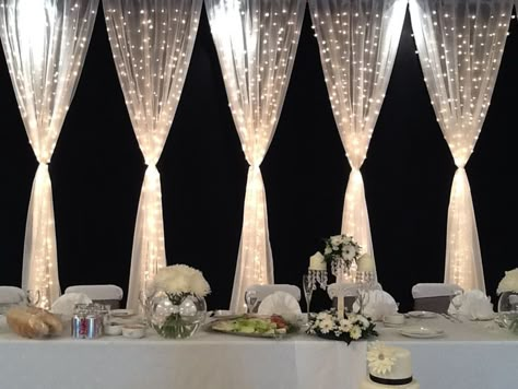 Pretty backdrop for the wedding party table. Gorgeous.  Tulle and twinkle lights make beautiful wedding decor. Maybe make it lavender Led Curtain Lights, Wedding Party Table, Curtain Lights, Twinkle Lights, Reception Ideas, Here Comes The Bride, Wedding Planners, Reception Decorations, Wedding Backdrop