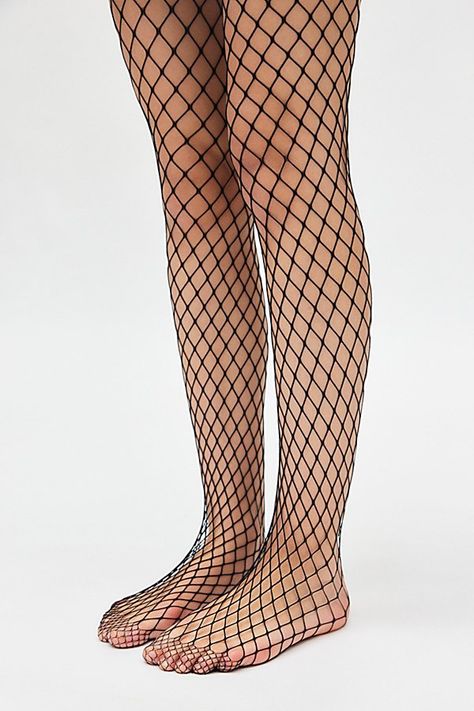 Forever favorite fishnet tights in a soft open-net finish. Features Fishnet tights Iconic netted tights Soft and stretchy Lightweight feel Content + Care 94% Nylon, 6% spandex Hand wash Imported Size + Fit S/M 4'10" -5'6" 90-130lbs L/XL 5'7" -5'6" 130-200lbs | Fishnet Tights in Black, Women's at Urban Outfitters Fish Net Bodysuit, Hand Fishnets, Netted Tights, Grunge Fishnets, Fishnet Stockings Outfit, Heathers Costume, Fish Net Tights Outfit, Spiderman Halloween Costume, Vintage Tights