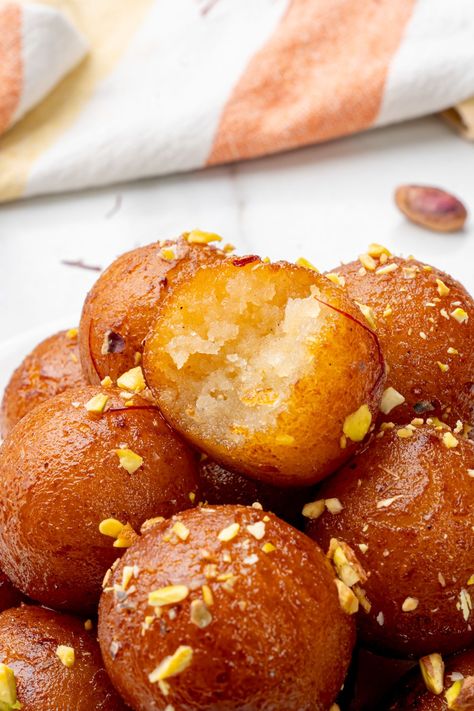 Gulab jamuns garnished with nuts Galub Jamun, Gulag Jamun, Indian Deserts, Deep Fried Donuts, Dessert Balls, Pakistani Desserts, Indian Desert, Gulab Jamun Recipe, Jamun Recipe