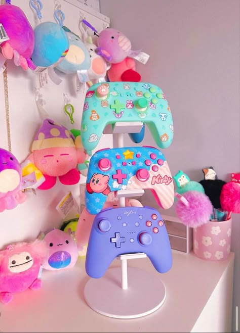 Its the little things. This is so cute for displaying all your cute controllers! #gamergirl #gamersetup #gamergirlsetup #kawaii #pastelgoth #pastelcore #pastelgamer #nintendoswitch #gamer #gamerneeds #organizedhome #kirby Cute Game Controller, Kawaii Gamer Setup, Xbox Setup Ideas, Kirby Gaming Setup, Ps5 Decoration, Xbox Controller Aesthetic, Kawaii Gamer Aesthetic, Xbox Controller Stand, Gamer Baby