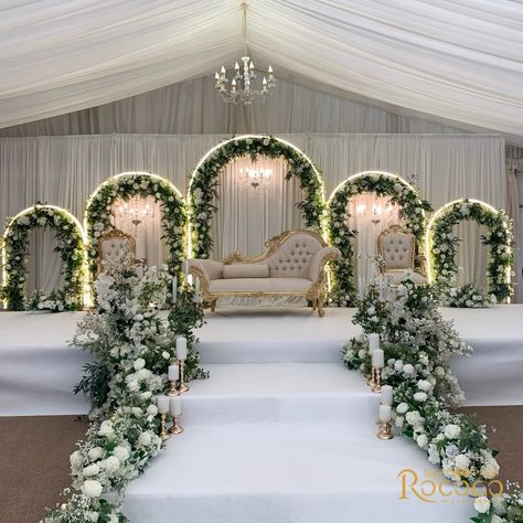 Absolutely loved creating this stunning wedding decor! 🤍 Swipe to see one of our favorite setups yet. #WeddingDecor #EventStyling Decor: @rococo.events Venue: @keythorpemanor #weddingdecorators #weddingdecorinspiration #eventdecorators #floraldecoration #weddinginsporation #ukweddingplanners #floralwedding white, green, gold, wedding theme, staging, archway, floral arch, table decor Floral Wedding Entrance Decor, Wedding Events Decoration, Green And White Wedding Stage Decor, White Floral Stage Decor, Wedding Decor Set Up, White And Green Themed Wedding, Wedding Decoration Green And White, Unique Reception Decor, Off White Wedding Decor