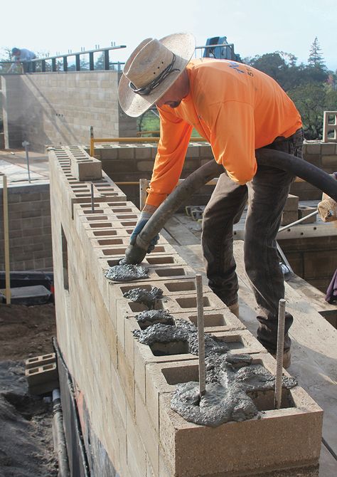 Edward De Reza of Watershed Materials uses a pump to fill blocks with concrete grout, which works with reinforcing steel to shore up the walls of the home. Concrete Block House, Rammed Earth Construction, Yard Privacy, Insulated Concrete Forms, Rammed Earth Homes, Concrete Block Walls, Cinder Block Walls, Shed Construction, Front Yard Landscaping Pictures