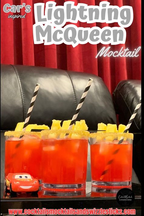 This image shows three red drinks with a yellow rim, pineapple garnish and black and white striped straws in a home movie theater with a Lightning Mcqueen car sitting next to them. Mock Tails For Kids, Disney Themed Cocktails, Disney Themed Drinks, Disney Movie Night Menu, Disney Themed Movie Night, Family Movie Night Ideas, Disney Movie Night Food, Disney Movie Night Dinner, Movie Dinner