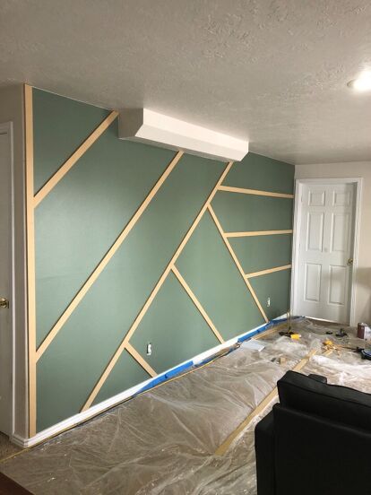 I was asked to help a friend makeover her basement, so we planned and I came up with this. This is where we started, she told me she wanted a modern industrial touch and she loved the geometric accent wall I did for my daughters bedroom 👇 So I went to work by drawing up a few different designs for her wall.once I was happy with the design I went to the hardware store and purchased a sheet of 1/2 mdf boardliquid nailand some nailsand I grabbed some primer and paintOnce I got h… Wood Accent Wall Pattern Ideas, Modern Bedroom Paint Colors Accent Wall, Accent Wall Bedroom Geometric, Accent Wall Colors Office, Bedroom Wall Geometric Designs, Geometric Wood Wall Design, White Slat Wall Bedroom, Accent Wall With Design, Designs For Accent Wall