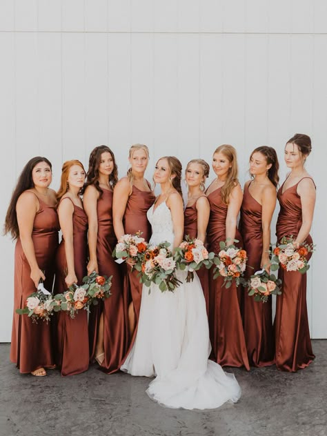 Satin rust bridesmaid dresses bring the perfect pop of color into a fall wedding color palette. Learn more about this summer wedding with fall vibes on our blog! Fall Wedding Bridesmaid Dresses Rust, Satin Fall Bridesmaid Dresses, Fall Satin Bridesmaid Dresses, Satin Rust Bridesmaid Dresses, Spice Colored Bridesmaid Dresses, Terracotta Rust Bridesmaid Dresses, Dusty Yellow Bridesmaid Dresses, Rust Satin Bridesmaid Dress, Autumnal Bridesmaid Dresses