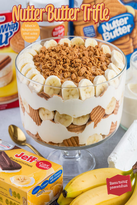 Sweet, creamy, and crunchy! This Nutter Butter Trifle with banana pudding and peanut butter drizzle will steal the show at your next get-together. Banana Trifle Recipes, Nutter Butter Banana Pudding Trifle, Nutter Butter Trifle, Banana Trifle Desserts, Thanksgiving Trifle Desserts, Nutter Butter Banana Pudding, Nutter Butter Dessert, Peanut Butter Trifle, Banana Trifle