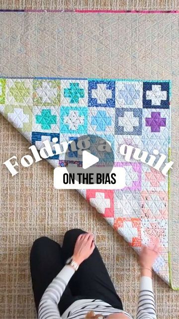 301K views · 17K likes | Shelly Moore on Instagram: "If you've ever heard someone say "you should fold your quilts on the bias" but didn't know what that meant (or if you should bother), then you'll want to check this out!

It's a simple and easy technique that anyone can do, and it will preserve and protect your quilts for the future. Don't have a huge living room floor? Lay your quilt out on a bed!

Want to learn more? Comment "FOLD" below and I'll send you a link to my full-length YouTube tutorial (where you can easily pause, rewind, and slow down the playback). 🎥

Quilt pattern: #scrapstashplusquilt (a free pattern) by @emily_dennis_" How To Fold Quilt, How To Fold A Quilt For Display, How To Fold A Quilt For Storage, How To Fold A Quilt For Gift, Folding Quilts For Storage, How To Fold A Quilt, Folding Quilts, Huge Living Room, Folding Hacks