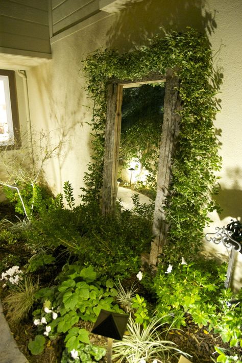 Add depth and visual interest to your outdoor space by strategically placing a mirror in the garden, whether against a wall, fence or shed, creating the illusion of more space and reflecting the beauty of your garden. Check our page for more garden lighting ideas! Outdoor Mirrors Garden Wall, Mirror In The Garden Ideas, Mirror In Backyard, Garden Mirrors On Fences, Mirror In Garden Ideas, Mirror In Garden, Garden Mirrors Ideas Outdoors, Diy Garden Mirror, Mirrors In Gardens