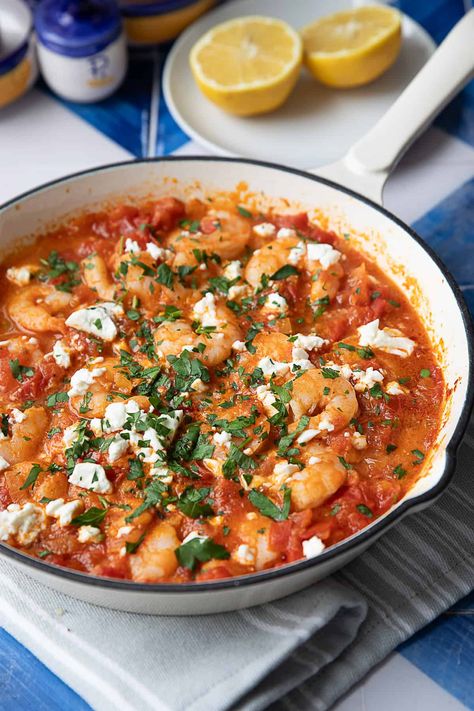 Shrimp Saganaki with feta and tomatoes is a quick and flavorful Greek dish that's perfect for a quick lunch or dinner. With shrimp, tangy feta, and a rich tomato sauce, it's both satisfying and easy to prepare. A simple one-pan recipe for those busy days where you're craving something flavorful. Shrimp Saganaki Greek, Shrimp Tomatoes Feta, Shrimp With Feta And Tomatoes, Shrimp Feta Recipes, Feta Tomato Recipe, Greek Seafood Dishes, Shrimp Feta Tomato Bake, Greek Tapas Recipes, Tomato Feta Recipes