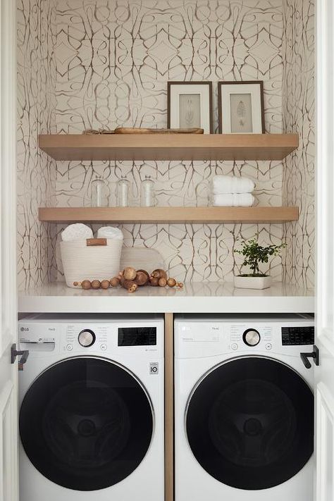 Laundry room closet features a washer and dryer and stacked floating shelves on Lindsay Cowles neutral A grasscloth wallpaper. Master Closet With Washer And Dryer, Closet With Washer And Dryer, Closet Wallpaper, Transitional Laundry Room, Blue Laundry Rooms, Laundry Room Storage Shelves, Hidden Laundry, Laundry Room/mud Room, Blue Mosaic Tile