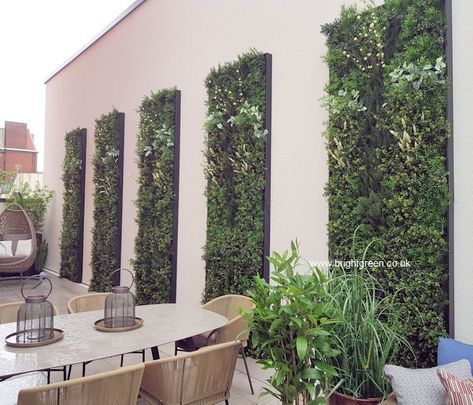 Custom Made set of Artificial Outdoor Living Wall Panels manufactured and installed in a courtyard location Artificial Living Wall Outdoor, Fake Green Wall Bathroom, Fake Green Wall Patio, Fake Living Wall, Artificial Plant Wall Outdoor, Artificial Ivy Wall Outdoor, Outdoor Green Wall With Neon Sign, Artificial Grass Wall Terrace, Artificial Foliage Wall Garden