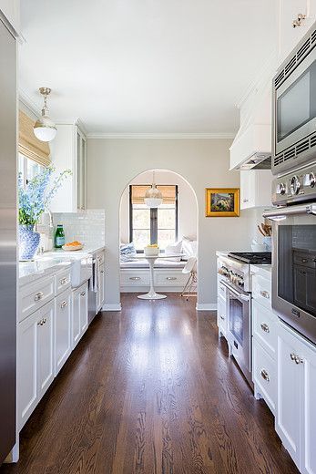 all white galley kitchen Breakfast Nook Beach House, Updated Galley Kitchen, Galley Kitchen With Breakfast Nook, Large Galley Kitchen, Galley Kitchen Cabinets, Ikea Galley Kitchen, Hicks Pendant, White Galley Kitchens, Farm Kitchen Ideas