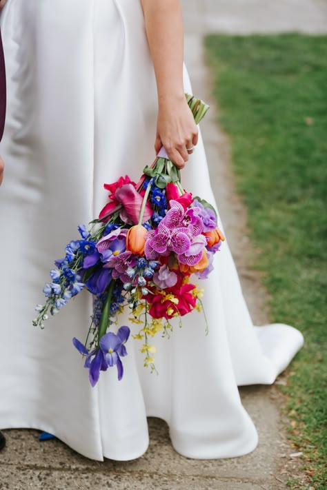 A bright and colourful bridal bouquet made by Anatomy of Flowers for a wedding. Vivid Wedding Flowers, Bright And Colourful Bridal Bouquet, Bright Colour Wedding Bouquet, Wedding Bouquets Bride Colorful, Rainbow Bridal Bouquet, Colourful Wildflower Bouquet, Bright Wedding Flowers Bouquet, Delphinium Wedding Flowers, Colourful Bride Bouquet