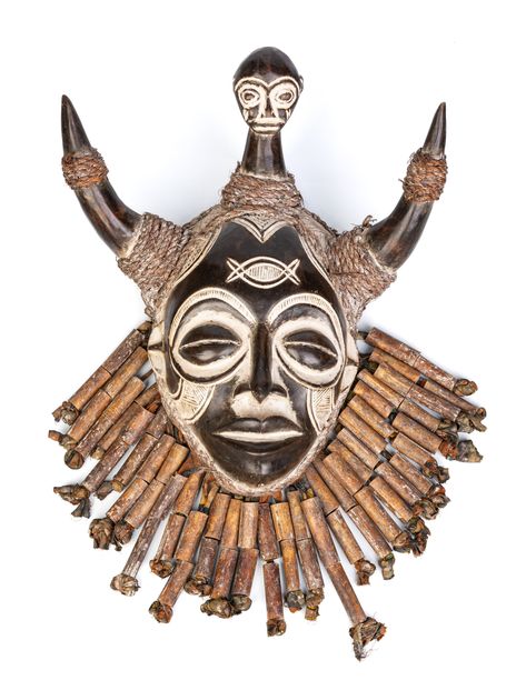 DESCRIPTION Large antique Chokwe mask, made of Panya Ngombe wood (also known as African ironwood), raffia fibers, barkcloth, bamboo, and rope. Decorated with animal horns, bamboo beards, and a small child head as the center piece. This rare collectible embodies themes of strength, power, wisdom, and spiritual connection, serving as a potent symbol of Chokwe identity, tradition, and cultural heritage. Made by the Chokwe people, who primarily inhabit regions of Angola, the Democratic Republic of the Congo (DRC), and Zambia. Chokwe masks are an integral part of their cultural and artistic heritage. These masks are known for their intricate designs and symbolism, often used in traditional ceremonies such as initiation rituals/rites of passage, harvest festivals, dance performances, community g Ancient African Art, Chokwe Masks, Cultural Outfits, Animal Horns, How To Draw Eyelashes, Congo Drc, Traditional Mask, Harvest Festivals, Music Designs