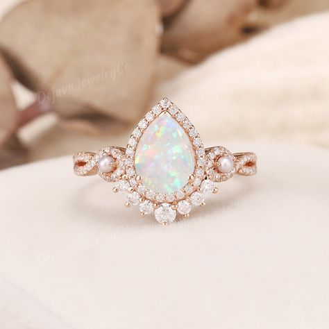 Vintage White Opal Engagement Ring Pearl Engagement Band Rose Gold Vine Ring Infinity Ring Flower Stacking Ring Unique Pear opal Ring Halo ✦ Handmade, high-quality item ✦ Material: SOLID 10K/14K/18K GOLD ( can be made in yellow/white/rose gold ) ✦Engagement ring ✦ Center stone: Lab opal  ✦ Size/Weight: 6*8mm ✦ Cut: Pear Shaped ✦ Side stones: Moissanite, or Natural Diamonds; and natural small pearls ✦ Weight: About 0.386ct  ✦ Color: DEF Color ✦ Cut: Round Shaped ✦ Band Width: Around 1.6mm PRODUCT Gold Opal Ring Engagement, Opal Pearl Ring, Pear Opal Ring, Engagement Ring Pearl, Opal Engagement Ring Vintage, White Opal Engagement Ring, Fairytale Engagement Rings, Trendy Silver Jewelry, Opal Wedding Ring