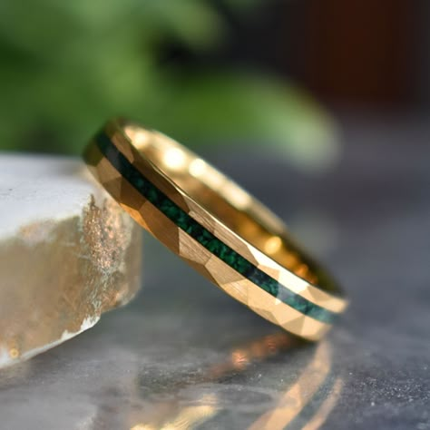 Discover the perfect blend of sophistication and strength with our 4mm Gold Hammered Tungsten Ring featuring a captivating Malachite Inlay. The hammered gold detailing adds a distinctive touch, while the malachite inlay not only introduces a burst of color but also brings with it the potential benefits of promoting balance and transformation. Embrace a durable symbol of your commitment, enriched with the unique properties of malachite – a stone believed to encourage positive energy and personal Mens Wedding Rings With Stone, Cool Wedding Bands For Men, Mens Wedding Rings Gold Unique, Gold Rings For Men Unique, Men’s Engagement Ring, Men’s Ring, Men’s Rings, Men’s Wedding Rings, Wedding Rings For Men Unique