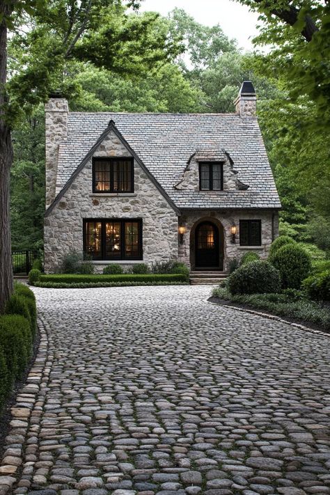 Modern English cottage front yard with cobblestone driveway lined with trees. Check out all of these modern English cottages that are as charming as they are functional. Can this be your dream home? Quaint Cottage Exterior, English Cottage Layout Floor Plans, Modern Stone Cottage Exterior, Small British Cottage, English Country Exterior Homes, English Cottage Home Exterior, New Stone House, English Cottage House Plans One Story, English Cottage Style House Plans