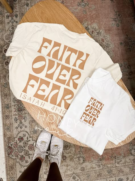 Faith Over Fear Graphic Tee  This tee is perfect for anyone who wants to show their faith and strength in the face of fear. It's a great way to encourage others and remind yourself that God is always with you. #christianapparel #faith #hope . #Cute_Trendy_Shirt_Designs #Faith_Over_Fear_Shirts #Easy_Tshirt_Design #Christian_Tshirt_Design_Ideas_Aesthetic Christian Tshirt Design Ideas Aesthetic, Print Clothes Design, One Color Tshirt Designs, Tshirt Front Design, Cute Tee Shirt Designs, Cute T Shirt Designs Graphic Tees, Cute Christian Graphic Tees, Vintage Graphic Design Tee, Cute Tshirt Designs For Women