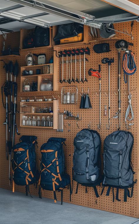 A garage with a pegboard backpacking gear wall displaying organized outdoor gear and backpacks. Hiking Gear Storage Wall, Outdoor Gear Storage Garage, Storage For Outdoor Gear, Garage Outdoor Gear Storage, Hiking Gear Wall, Outdoor Gear Room Ideas, Camping Gear Storage Garage, Ebay Storage Ideas, Hiking Gear Storage Ideas