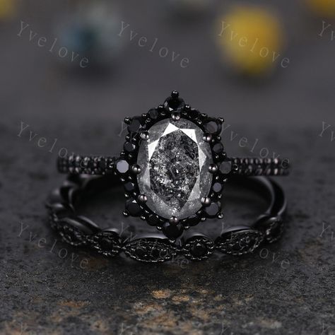 Gothic Oval Shape Salt and Pepper Diamond Engagement Ring Set,Black Gold Diamond Promise Ring Unique Rhodium Black Witchy Ring Bridal Gift,Anniversary Ring Gift For Her,moissanite band ,antique ring set for women Material: Solid gold (10k 14k 18k rose gold,yellow gold,white gold,Platinum available) Main stone:6x8mm oval Cut natural Salt and Pepper Diamond(Every stone will be unique and vary!) Side stone:with black spinel halo and wedding band  0.25ct round cut real diamonds Band width:approx 1.8 Rose Gold Black Diamond Ring Engagement, Gothic Style Wedding Rings, Oval Cut Black Sandstone Ring, All Black Engagement Ring, Rose Gold And Black Engagement Ring, Black Rings For Women Engagement, Unique Gothic Engagement Rings, Gothic Wedding Rings Set, Grunge Engagement Ring