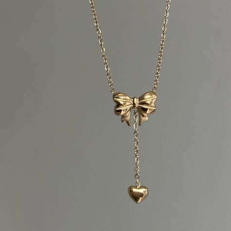 "Bow Drop Heart Necklace  ✨ Fully stainless steel & tarnish proof! (18k gold plated) 15.5\" with a 2\" extender  oval link chain style featuring a unique mini gold puffed bow pendant & mini heart pendant 🤍 Handmade with love!" K Jewelry, Jewelry Accessories Gold, Cute Heart Necklace, Jelewry Gold, Gold Necklace With Heart Pendant, Pretty Jewellery Gold, T Necklace, Dainty Jewellery, Heart Shaped Locket