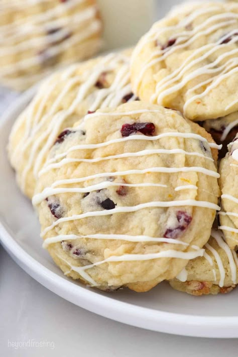 Soft and Chewy Cranberry Orange Cookie with a white chocolate glaze. They're buttery, perfectly chewy with crisp edges, and bursting with flavor. These make a great Christmas cookie! Cranberry Cheesecake Bars, White Chocolate Glaze, Beyond Frosting, Best Snickerdoodle Cookies, Chocolate Orange Cookies, Cranberry Orange Cookies, Cookie Recipes Decorating, Cookie Cups Recipe, Peanut Butter Blossom Cookies