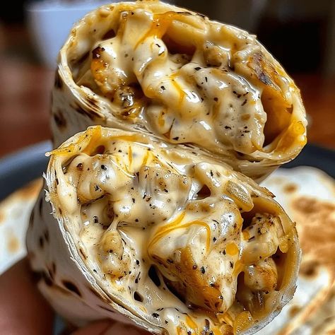 Cheesy Garlic Chicken Wraps: A Deliciously Easy Meal - MmmRecipes : Easy and Delicious Recipes Cheesy Garlic Chicken, Chicken Wrap Recipes, Creamy Garlic Sauce, Chicken Wrap, Chicken Wraps, Cheesy Chicken, Wrap Recipes, Garlic Chicken, Flavorful Recipes