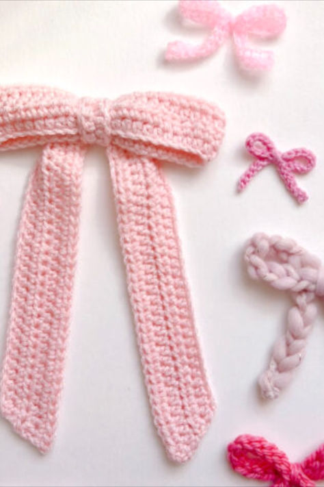 Think ballet, Bridgerton, and Barbie, all rolled into one. While you can make your coquette bows with ribbon, crocheting them will bring an even softer and dreamier feel. Designer Twinkie Chan gives you 4 easy and free crochet bow patterns and a few ideas on how to use them. Crochet Pattern Projects, Craft Crochet, Crochet Bow For Amigurumi, Ribbon Crochet Pattern Free, How To Crochet A Ribbon, Crochet Bows Hair, Ribbon Crochet Pattern, Knit Ideas For Beginners, Crochet Patterns Accessories