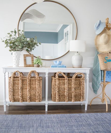 Spring brings with it a little refresh… There’s something about spring that calls for a little home update! 🌸 Our coastal-inspired entry got a fresh look. The woven baskets add warmth, while the larger round mirror reflects light, making the space feel bright and airy. 🧺💙 I love how the white console table creates a perfect balance between style and function—plenty of storage with a clean, crisp look. 🌊 A few subtle decor pieces, like the eucalyptus in a textured vase, bring the outdoors in ... Coastal Entryway Ideas Front Entry, Beachy Entryway, Coastal Entryway Ideas, Entrance Console Table, Coastal Entryway, Textured Vase, White Console Table, Large Round Mirror, College House