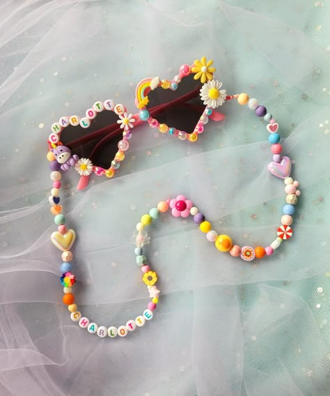 These chic Custom Mix Bead Sunglasses Chains are styled to express your child's vibrant and playful personality. They look fun and perfect to pair with our Personalized sunnies.These will also help your little ones keep their sunnies with them all day. No more forgetting your sunnies! Our sunny chains are each made by hand and of mixed colorful beads that will surely be unique to your child. All our designs are unique and have no duplicates. What you need to knowWARNING! CHOKING HAZARD! Contains Gen Z Crafts, Sunglasses With Beads, Sunglasses Chains, Kids Jewelry Diy, Flower Hearts, Beaded Sunglasses, Anting Manik, Sunglasses Design, Beads Art