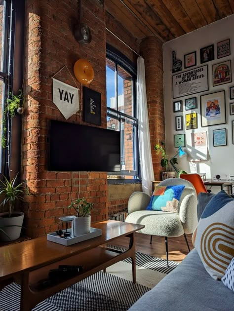 Strong light and shadow against a double-height gallery wall in a loft apartment decorated with colourful homewares and vintage furniture Mill Building Apartment Decor, New York Town House Interiors, Maximalist New York Apartment, Warehouse Style Apartment, Brick Apartment Living Room, Brick Wall Apartment Decor, Brick Wall Room Decor, Exposed Brick Apartment Aesthetic, Brick Loft Apartment Decor